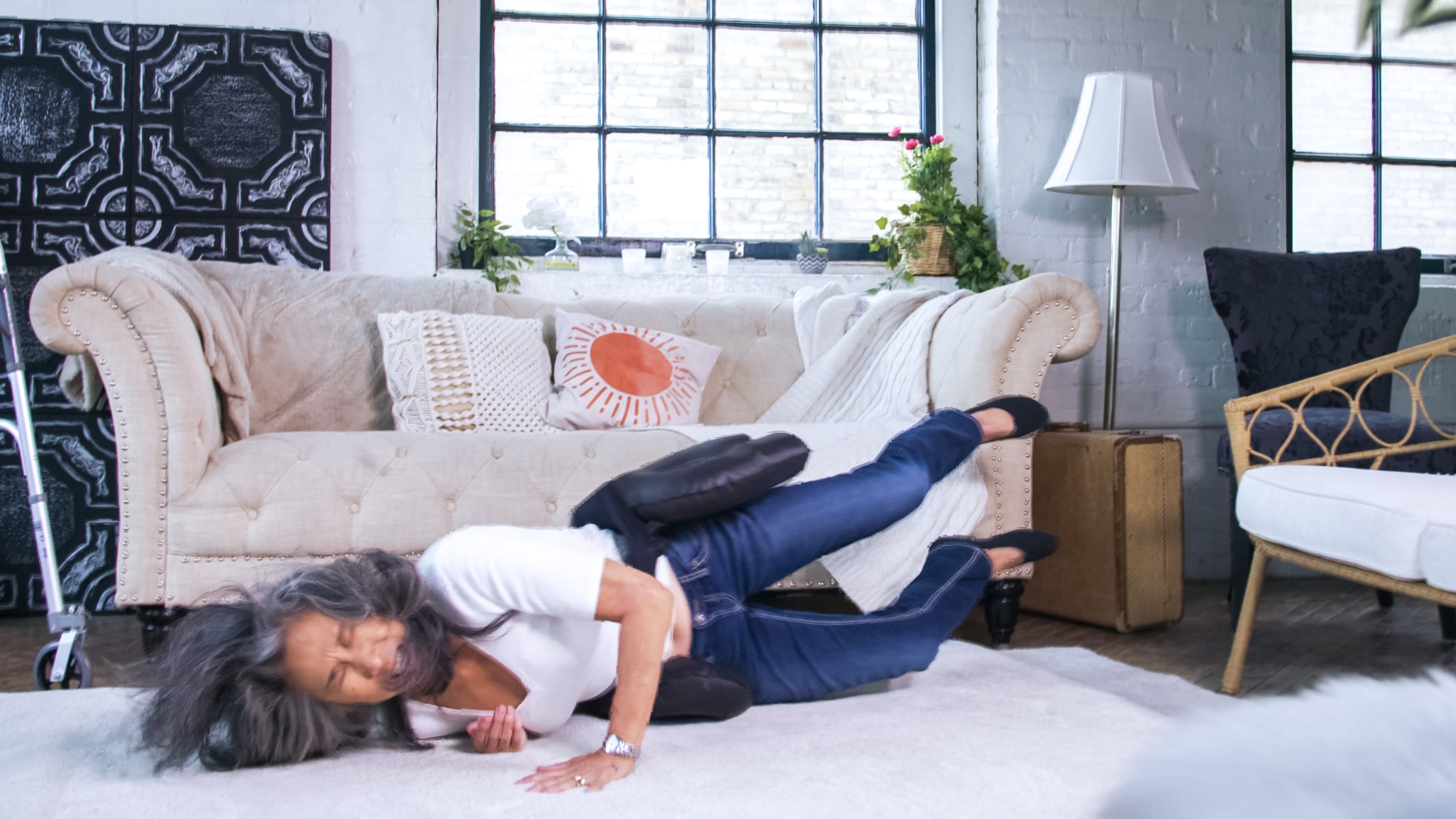 Woman who fell and is landing on the ground while the Smart Hip Guardian belt deploys